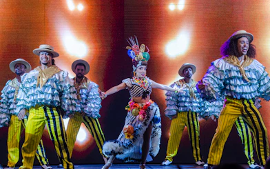 Performers in vibrant costumes dancing at Roxy Dinner Show, Rio de Janeiro.