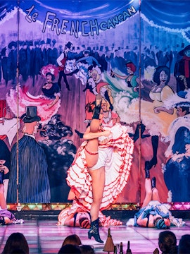 Cabaret performers on stage at Nouvelle Eve in Paris, featuring vibrant costumes and dynamic choreography.