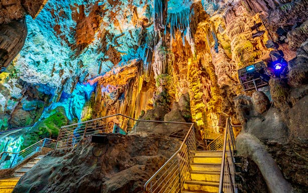 Stalactites and colorful lighting inside St. Michael's Cave, Gibraltar, on a tour from Málaga.