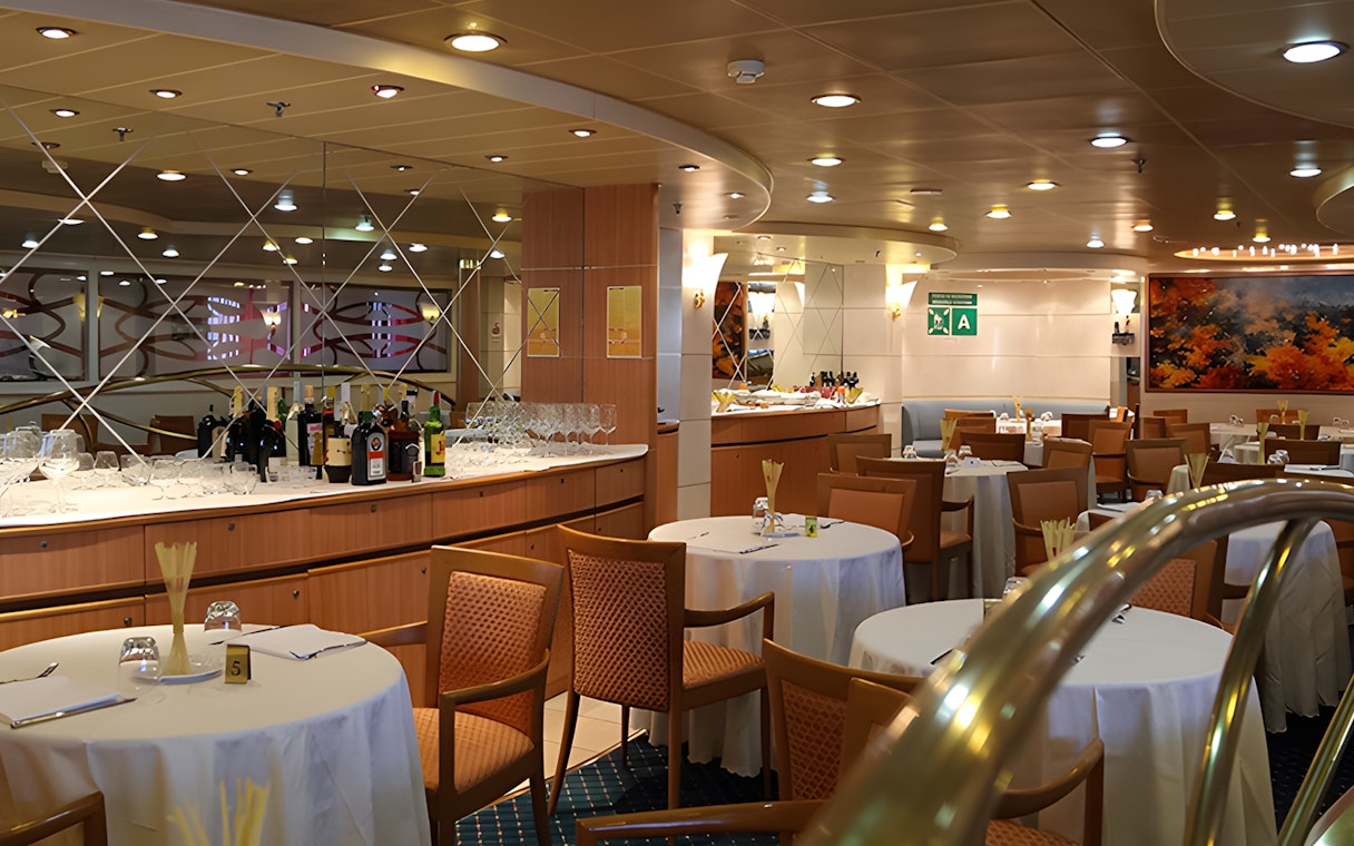 Dining area on SNAV ferry from Naples to Capri with tables and bar setup.