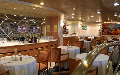 Dining area on SNAV ferry from Naples to Capri with tables and bar setup.