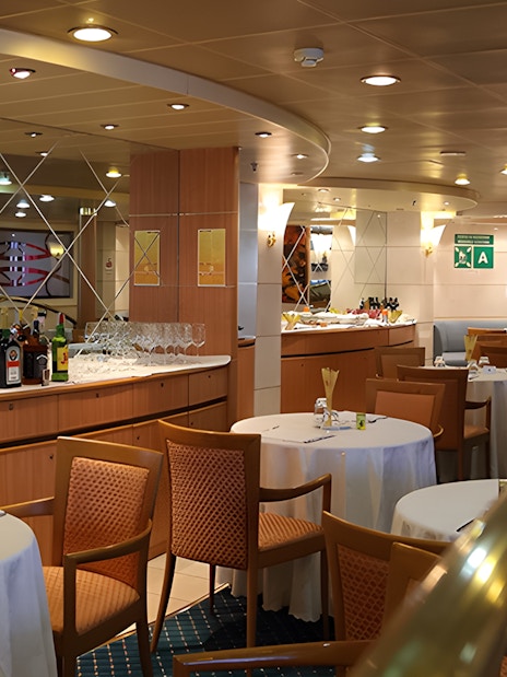 Dining area on SNAV ferry from Naples to Capri with tables and bar setup.