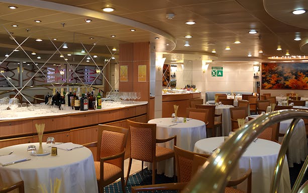 Dining area on SNAV ferry from Naples to Capri with tables and bar setup.