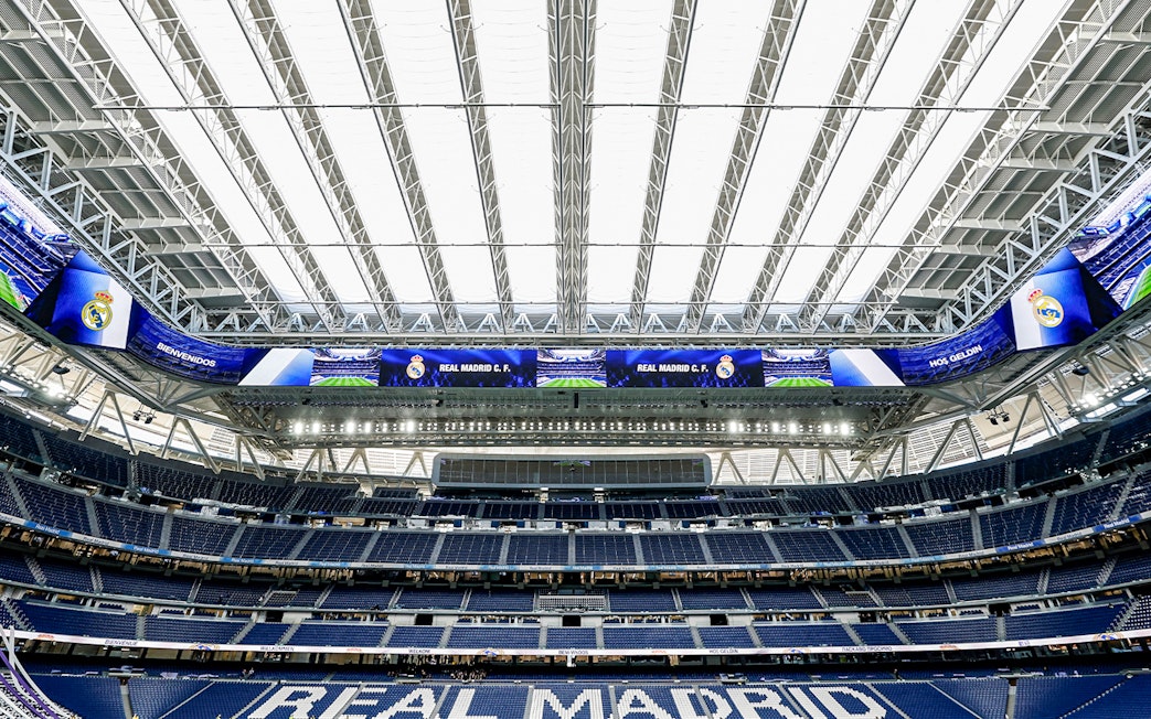 Santiago Bernabeu stadium interior with Real Madrid signage.