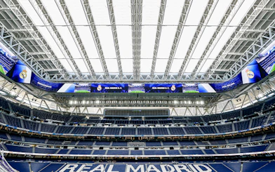 Santiago Bernabeu stadium interior with Real Madrid signage.