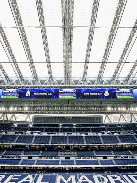 Santiago Bernabeu stadium interior with Real Madrid signage.