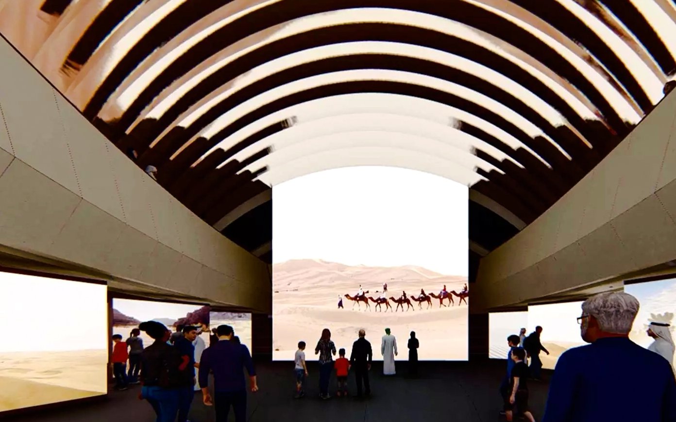Visitors viewing desert camel caravan exhibit at Zayed National Museum.