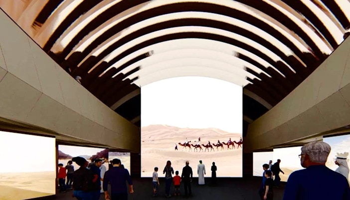 Visitors viewing desert camel caravan exhibit at Zayed National Museum.