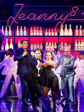 Dancers performing on stage at Ronach Theater with neon sign and bar backdrop.