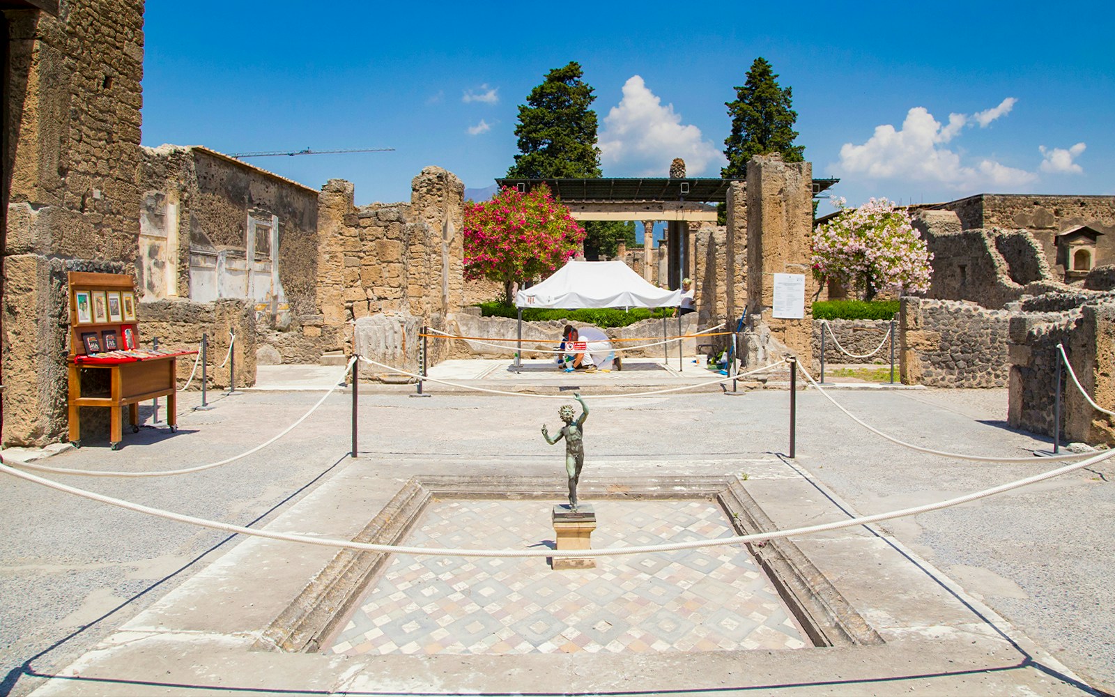 House of the Faun courtyard with bronze statue, Pompeii ruins.