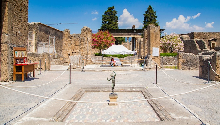 House of the Faun courtyard with bronze statue, Pompeii ruins.