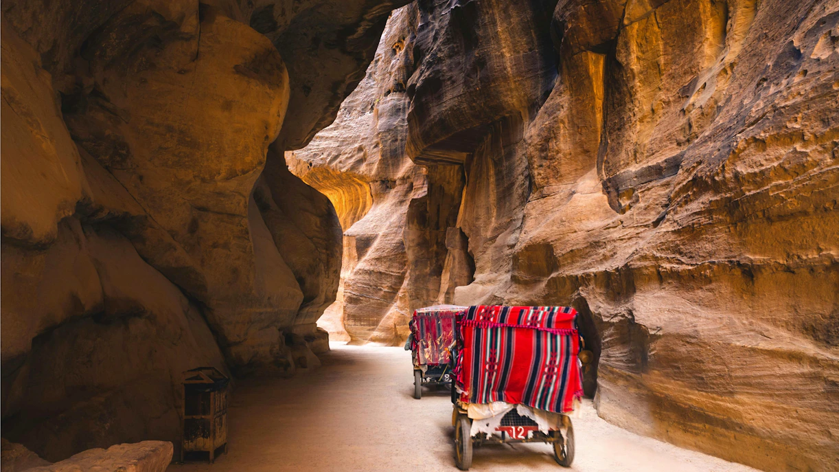 Horse cart traveling through the narrow Siq entrance to Petra, Jordan.