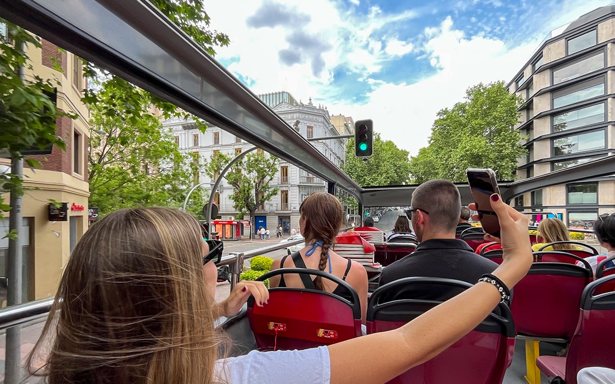 Open-top bus view of Madrid cityscape on City Sightseeing Madrid Hop On Hop Off tour.