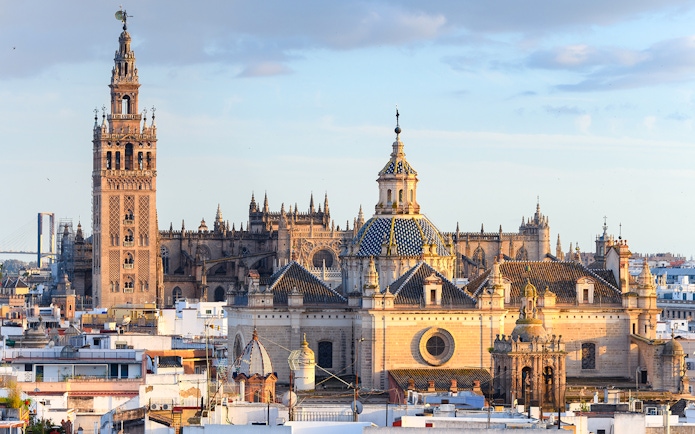 Seville Cathedral and Giralda tower with cityscape in Seville, Spain.