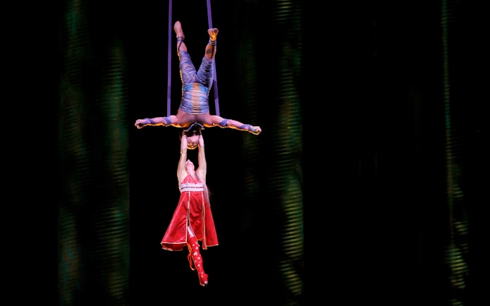 Acrobats performing aerial act in Cirque du Soleil KÀ show.