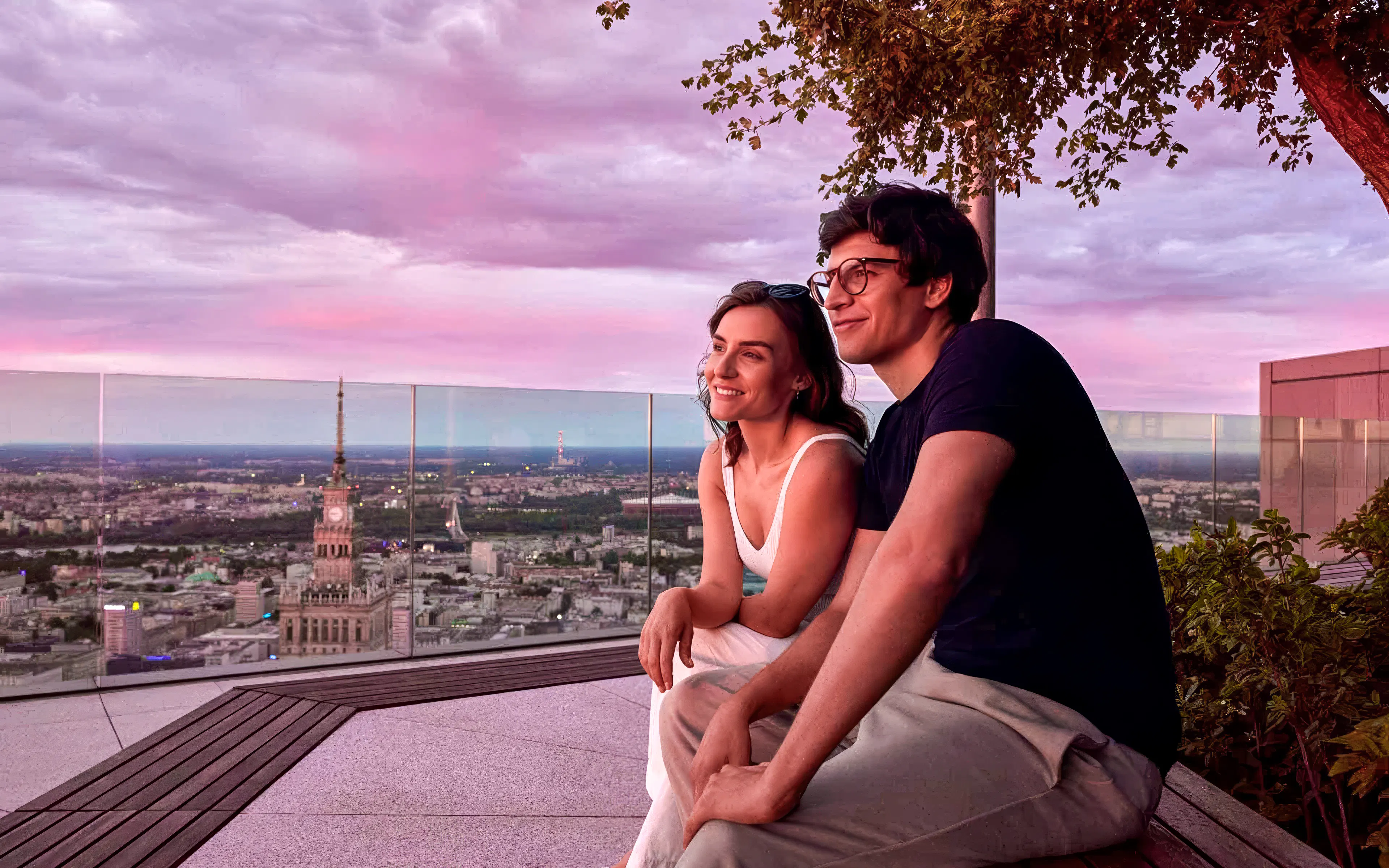 Couple enjoying sunset views from Highline Warsaw observation deck.