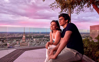 Couple enjoying sunset views from Highline Warsaw observation deck.