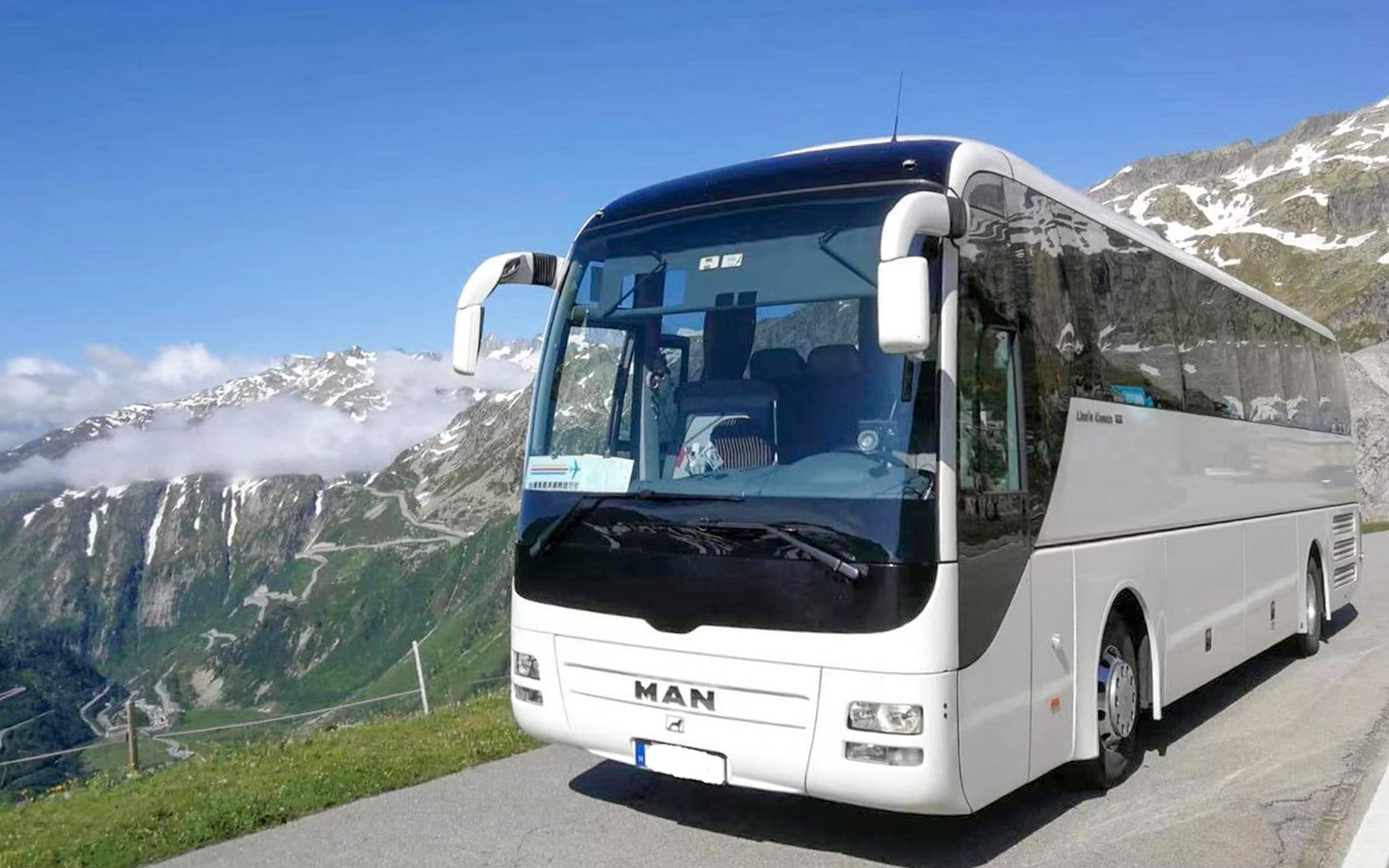 Bus on scenic mountain road during Danube Bend tour from Budapest.