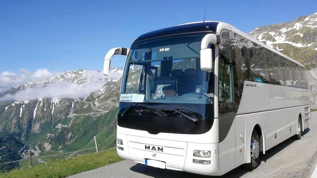 Bus on scenic mountain road during Danube Bend tour from Budapest.