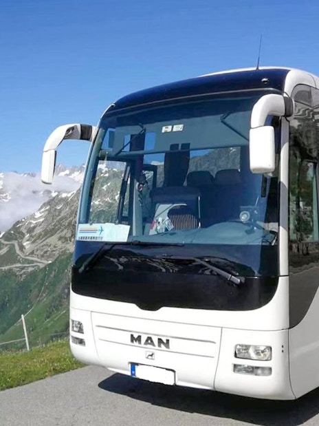 Bus on scenic mountain road during Danube Bend tour from Budapest.