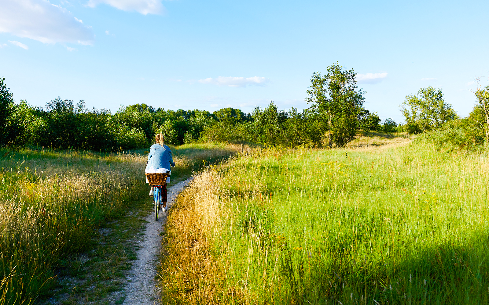 Cycling on a path through green fields near Chenonceau Castle, France.