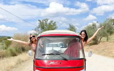 Tuk Tuk on Tuscany road with two people enjoying countryside views.