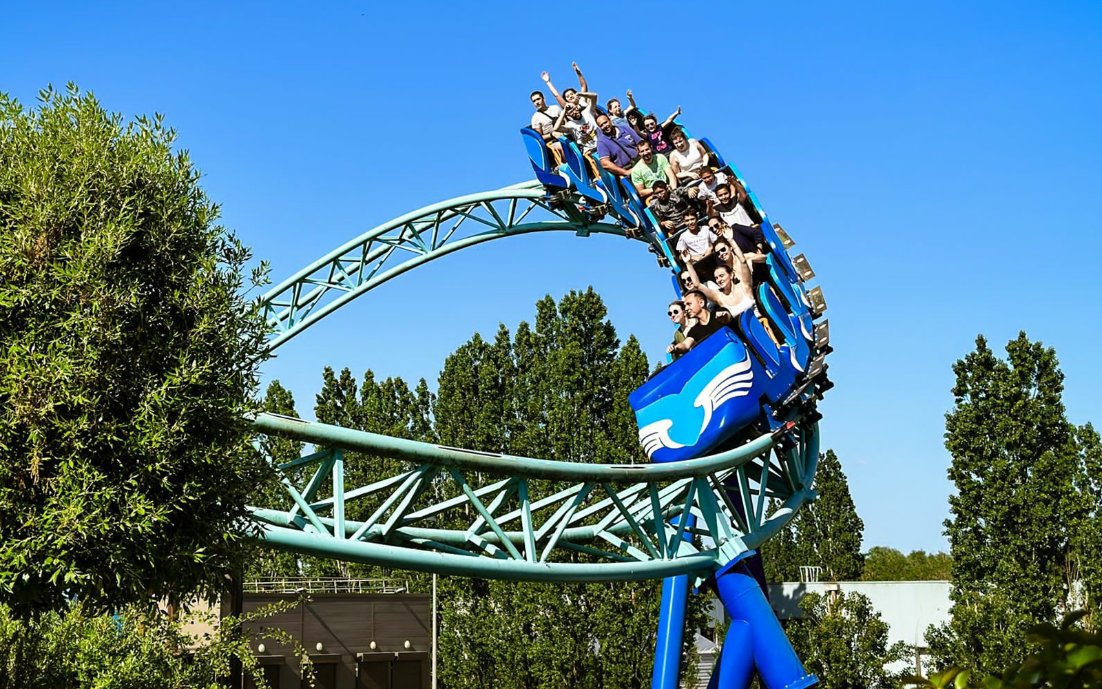 Pegase Express roller coaster ride at Parc Asterix, France, with excited tourists enjoying the thrilling experience