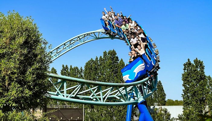Pegase Express roller coaster ride at Parc Asterix, France, with excited tourists enjoying the thrilling experience