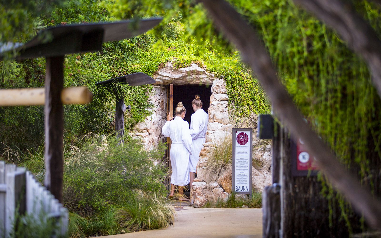 Visitors entering a stone sauna at Peninsula Hot Springs, Australia.