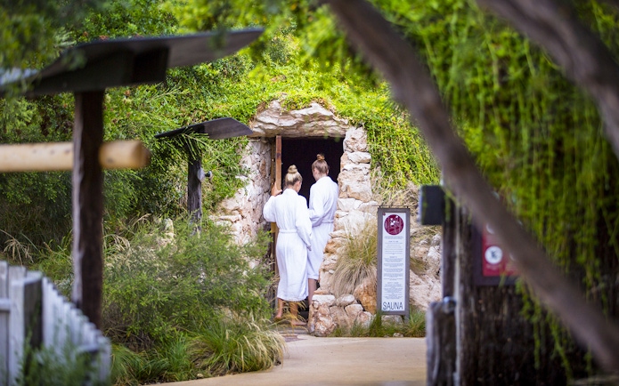 Visitors entering a stone sauna at Peninsula Hot Springs, Australia.