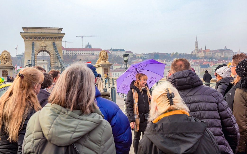Group tour on Budapest's Chain Bridge with views of the Hungarian Parliament.