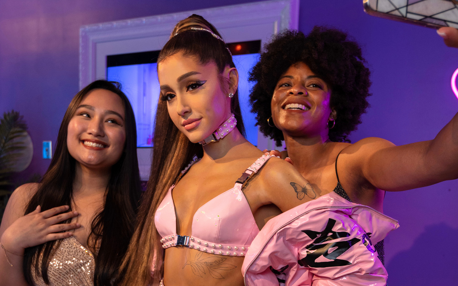 Wax figure of Ariana Grande with visitors at Madame Tussauds Orlando.