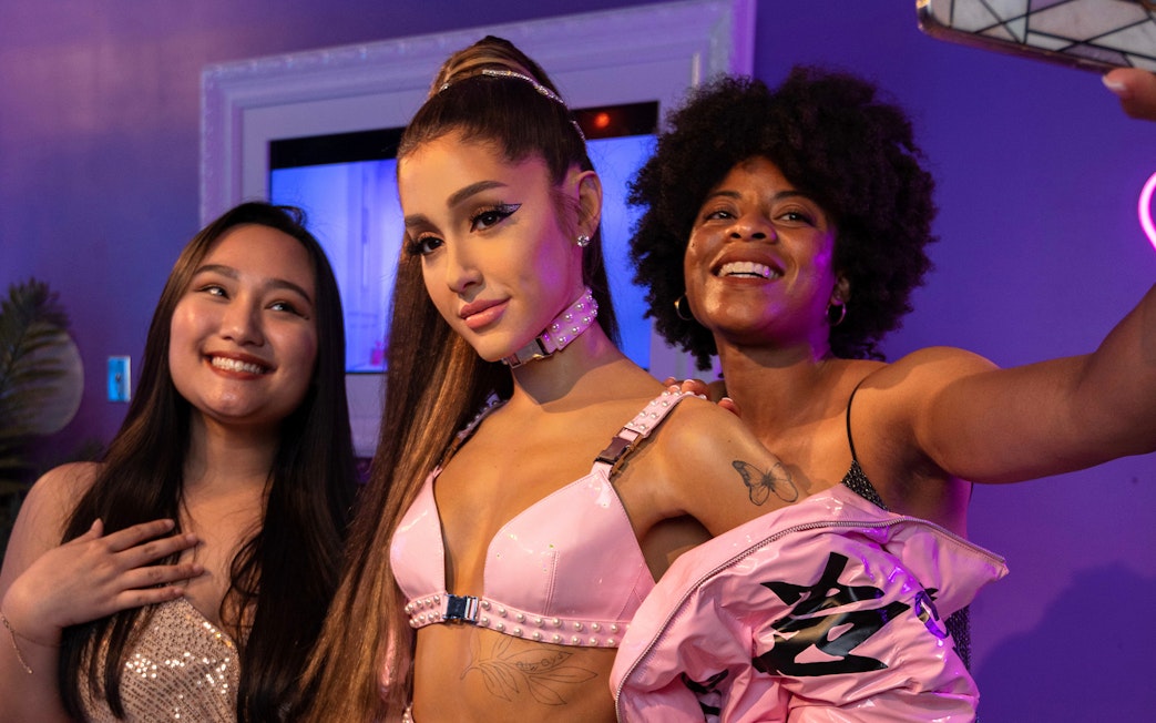 Wax figure of Ariana Grande with visitors at Madame Tussauds Orlando.