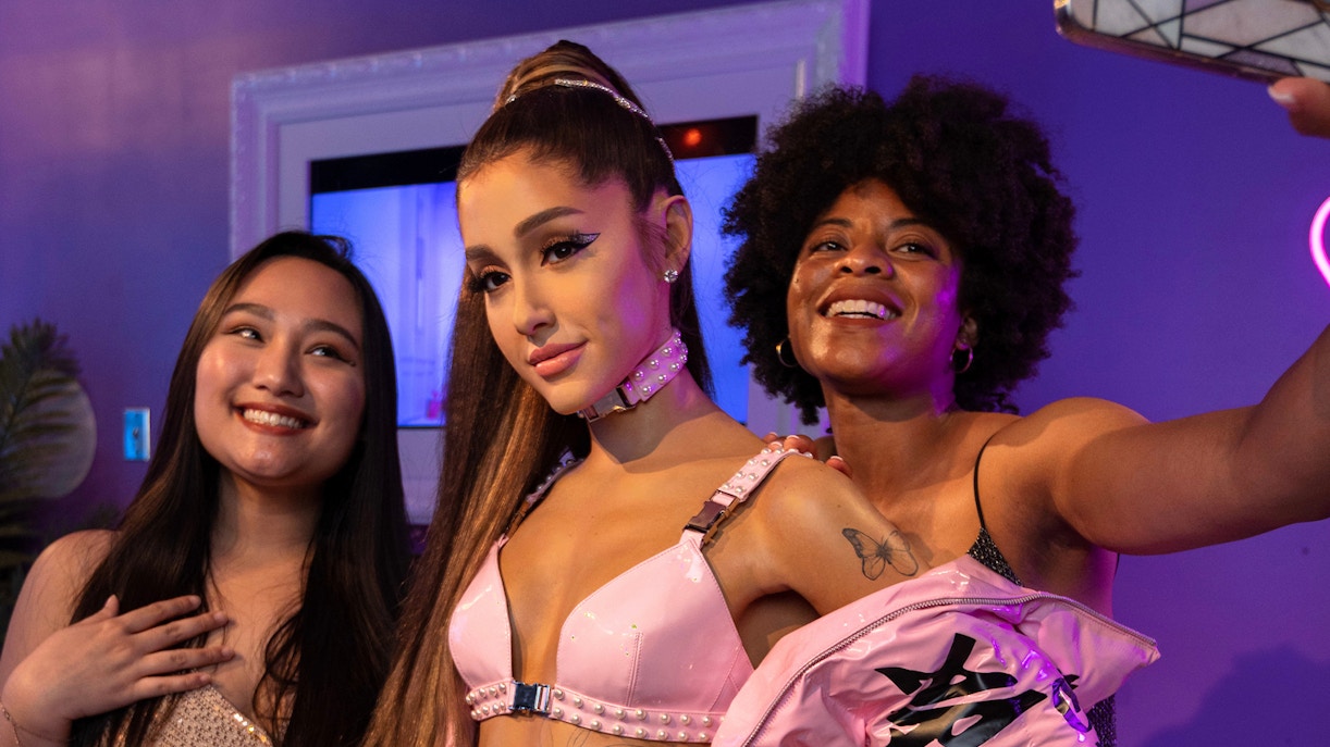 Wax figure of Ariana Grande with visitors at Madame Tussauds Orlando.