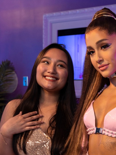 Wax figure of Ariana Grande with visitors at Madame Tussauds Orlando.