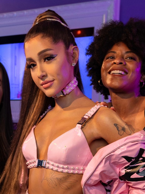 Wax figure of Ariana Grande with visitors at Madame Tussauds Orlando.