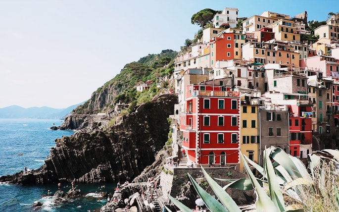 Colorful cliffside buildings in Riomaggiore, Cinque Terre, overlooking the sea.