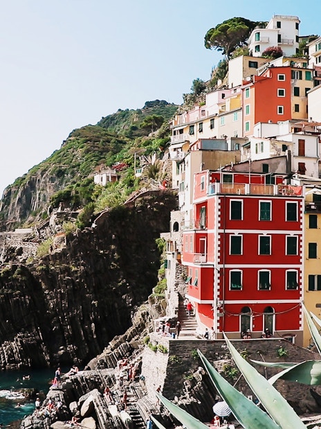 Colorful cliffside buildings in Riomaggiore, Cinque Terre, overlooking the sea.