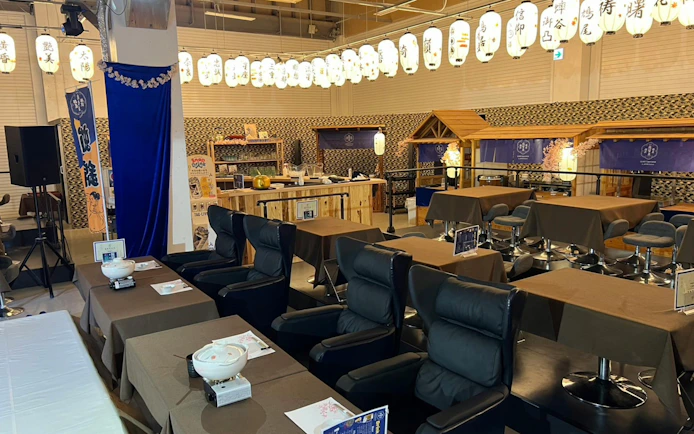 Sumo practice venue with seating and Chanko-Nabe hot pot setup at Ochiizumibeya, Japan.