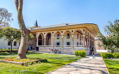 Entrance to Harem and Garden of Topkapi Palace, Istanbul, with visitors exploring.