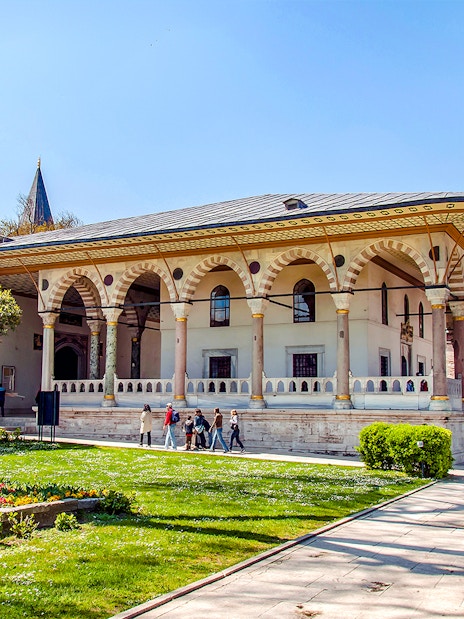 Entrance to Harem and Garden of Topkapi Palace, Istanbul, with visitors exploring.