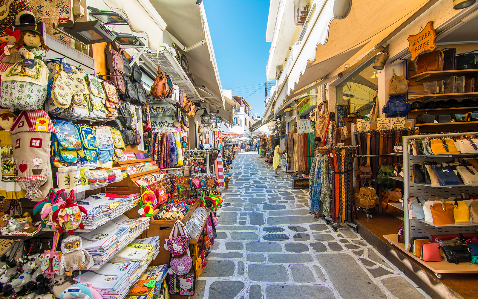 Shopping street with colorful bags and souvenirs in Kos Island, Greece.