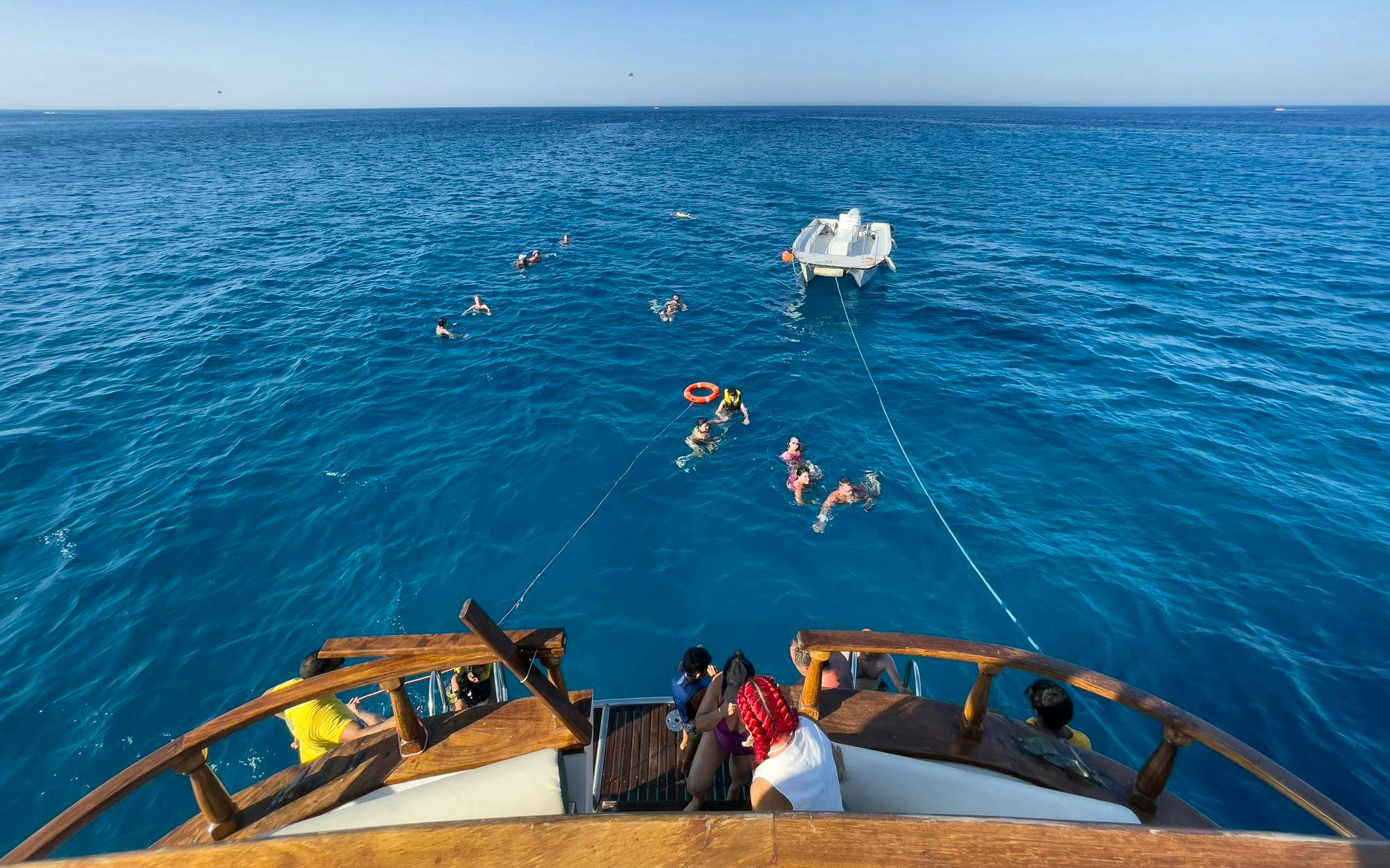 People swimming near a boat during the Blue Lagoon sunset cruise from Ayia Napa.