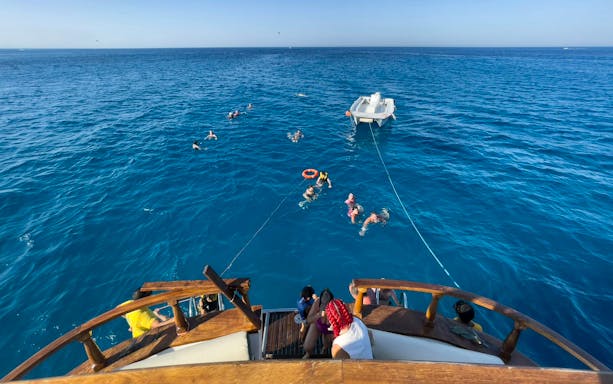 People swimming near a boat during the Blue Lagoon sunset cruise from Ayia Napa.