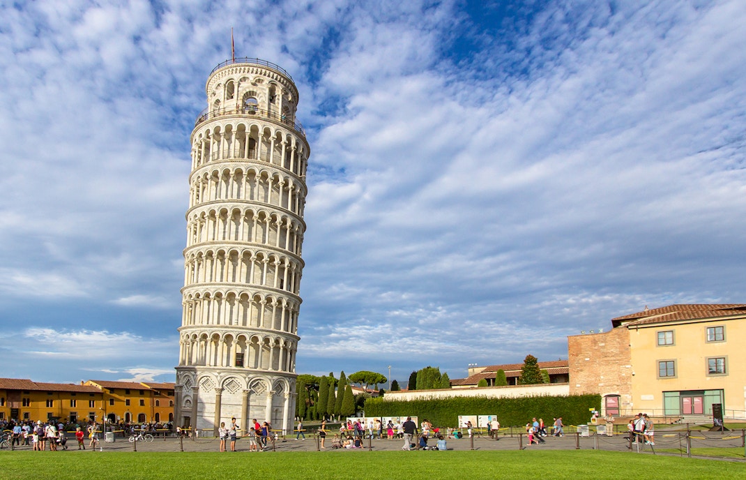 Leaning Tower of Pisa with tourists in foreground, Pisa, Italy.