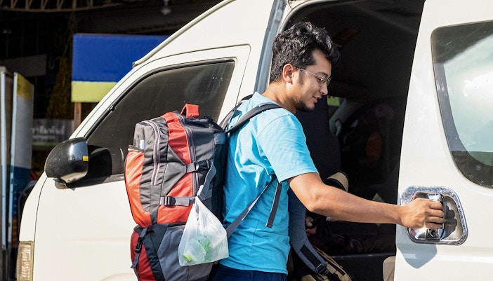 Man entering a van for round trip transfer to Zoo Negara and Panda Conservation Centre.