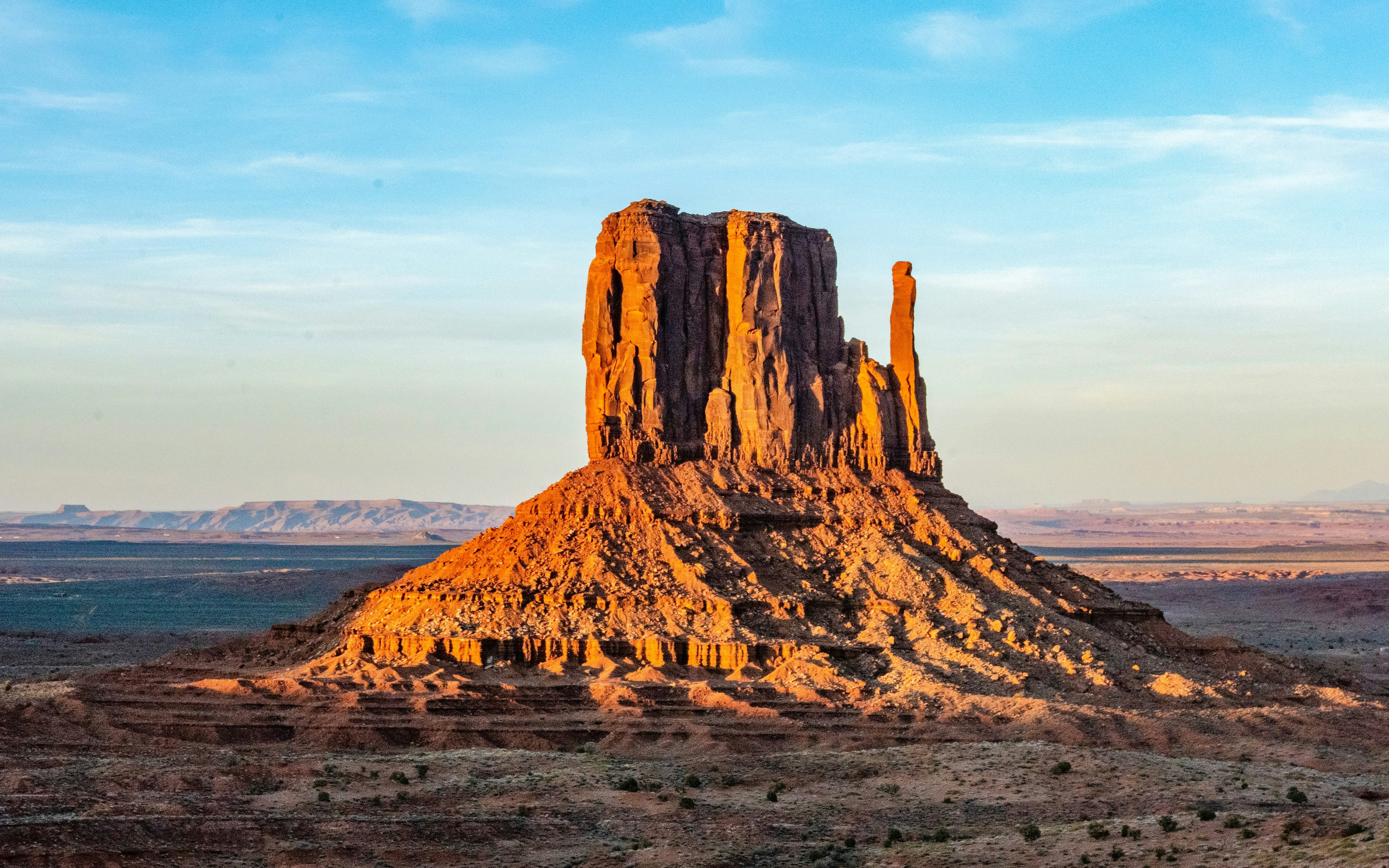 Monument Valley's Camel Butte under a clear blue sky.