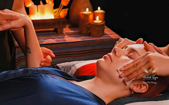 Relaxing facial massage at Herbal Spa, Da Nang with candles in the background.
