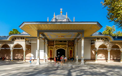 Gate of Felicity entrance at Topkapi Palace, Istanbul, with visitors exploring the historic site.