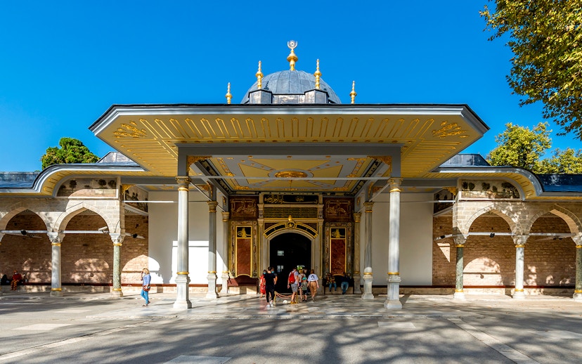 Gate of Felicity entrance at Topkapi Palace, Istanbul, with visitors exploring the historic site.